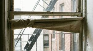 Professional Shades - Custom Window Treatments NYC 5 uneven roller shade in NYC apartment window